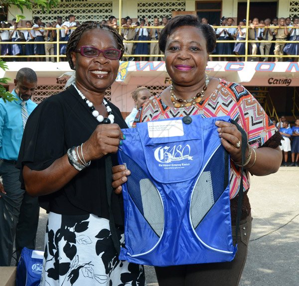 Ian Allen/Photographer
Avis Walker-Gordon left, VIce Principal of the Holy Family Primary School presents Patricia Park-Richardson right with a Gleaner 180th anniversary bag on Teachers Day on Wednesday.