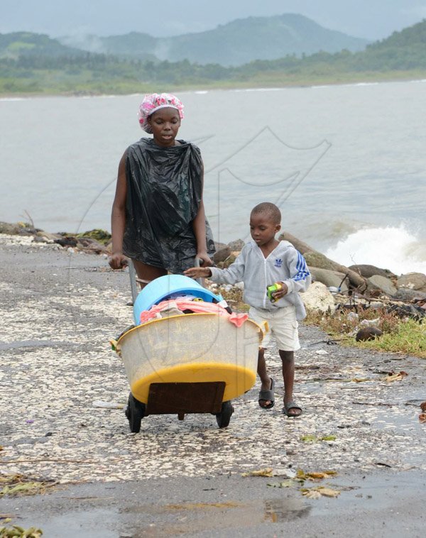 Ian AllenThese residents of  Port Arthur Lane in Annotto Bay, St Mary, make their way to a nearby shelter.