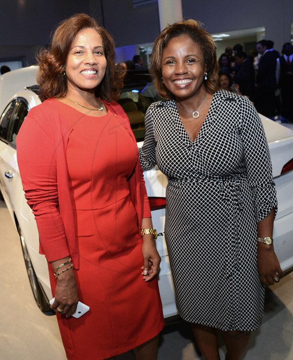 Donna Clarke - Manager of the New Kingston, National Commercial Bank (left) shares her fascination with the Hyundai Sonata 2016 with her friend, Ivally McDonald - Attorney-at-law at Debbie-Ann Gordon & Associates.