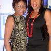 Rudolph Brown/Photographer
Alicia Knight (left) pose with Judith Wilson Insurance Association of Jamaica Christmas in November red and black party at the Guardian Life car park in New Kingston on Saturday,  November15-2014.