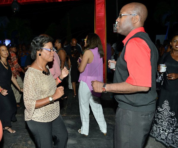 Rudolph Brown/Photographer
Insurance Association of Jamaica preident Hugh Reid, dancing with his wife Claudette  at the IAJ Christmas in November party held at the Guardian Life car park in New Kingston on Saturday, November 16, 2013.