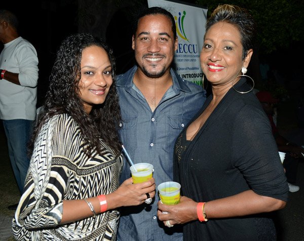 Rudolph Brown/Photographer
Stephen Robotham pose with Sharika Saunders, (left) and Elaine McKenzie at the IAJ Christmas in November party held at the Guardian Life car park in New Kingston on Saturday, November 16, 2013.