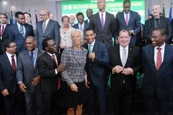 *** Local Caption *** @Normal:Christine Lagarde (centre), managing director, International Monetary Fund (IMF), with (from left in the front row) K. Peter Turnquest, deputy prime minister and minister of finance of The Bahamas; Vance Amory, premier of Nevis; Keith Mitchell, prime minister of Grenada; Prime Minister Andrew Holness; Audley Shaw, finance minister; and Ambassador Dr Nigel Clarke, deputy chair of the Economic Growth Council, quite animated at the opening of the IMF High Level Caribbean Forum in Kingston, yesterday.