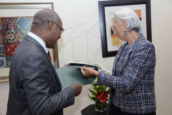 Rudolph Brown/ PhotographerIan Boyne, Deputy CEO of JIS Hand over USAIN Bolt legend book to Christine Lagarde, IMF Managing Director  at the opening Ceremony of IMF High Level Caribbean Forum at the Jamaica Pegasus Hotel in New Kingston on Thursday, November 16, 2017