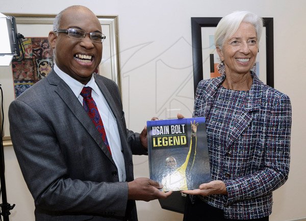 Rudolph Brown/ PhotographerIan Boyne, Deputy CEO of JIS Hand over USAIN Bolt legend book to Christine Lagarde, IMF Managing Director  at the opening Ceremony of IMF High Level Caribbean Forum at the Jamaica Pegasus Hotel in New Kingston on Thursday, November 16, 2017 *** Local Caption *** Rudolph Brown/ PhotographerIan Boyne, deputy CEO of JIS presents a copy of the USAIN Bolt Legend book to Christine Lagarde, International Monetary Fund (IMF) managing director at the opening eremony of IMF High Level Caribbean Forum in Kingston yesterday.