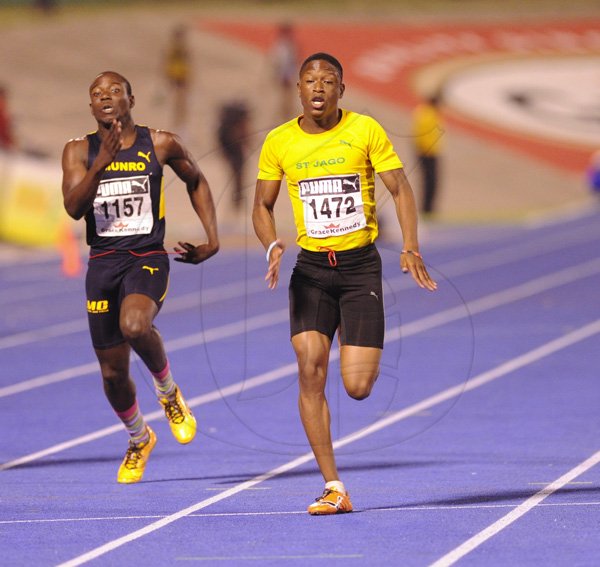 Ricardo Makyn/Staff Photographer
Left Rushane Edwards of Munro pursues Raheem Chambers of St Jago winner of the Boys' Class 3,100 Final at the Boys and Girls Championships at the National Stadium on Friday 30.3.2012