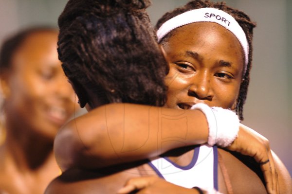 Ricardo Makyn/Staff Photographer
Shellece Clarke of Edwin allen is congratulated by aanother Athlete after winning the Girls Class 4 100 Meters Final  at the Boys and Girls Champs 2012