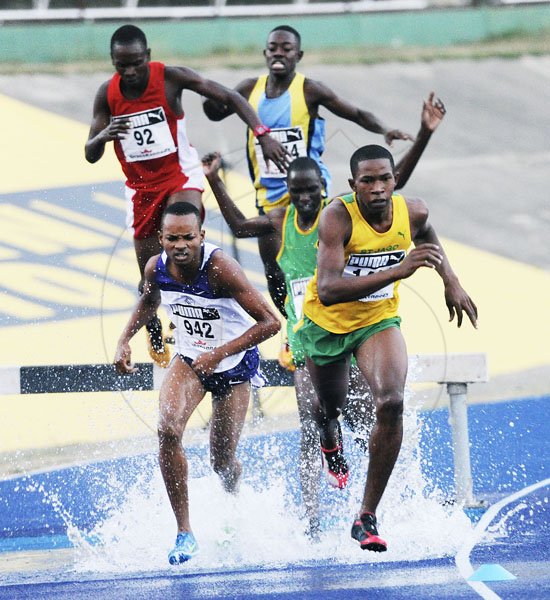 Ricardo Makyn/Staff Photographer
Roshawn Johnson of St Jago High School  leading the field to win heat 2 of the Boys' Open 2000 Steeple Chase at the National Stadium at Boys and Girls Champs 2012