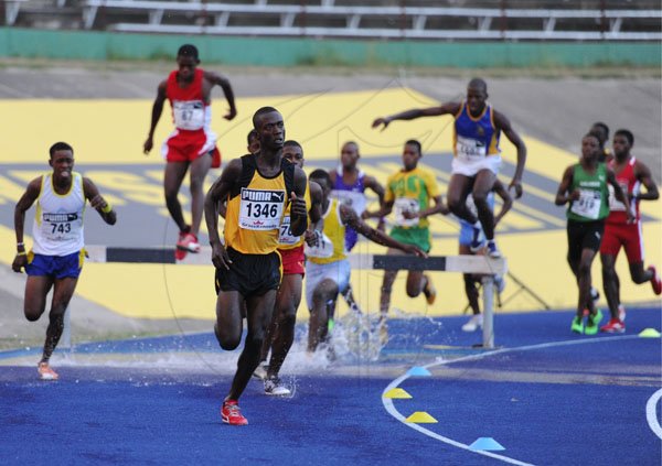 Ricardo Makyn/Staff Photographer
Rodney Henry of Spaldings High School leading the field to win heat 1 of the Boys' Open 2000 Steeple Chase at the National Stadium at Boys and Girls Champs 2012