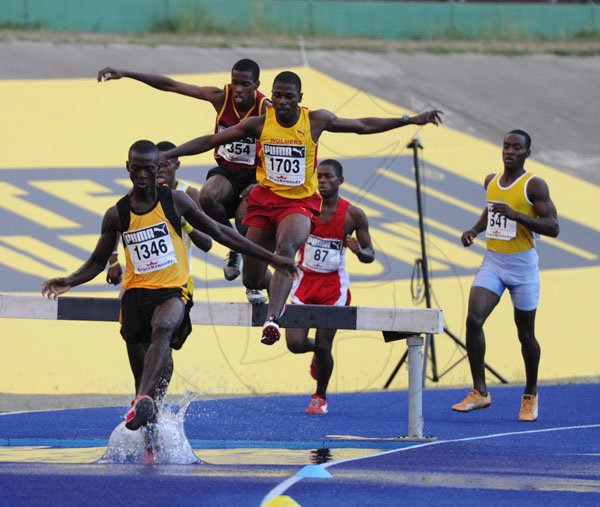 Ricardo Makyn/Staff Photographer
Rodney Henry of Spaldings High School leading the field to win heat 1 of the Boys' Open 2000 Steeple Chase at the National Stadium at Boys and Girls Champs 2012