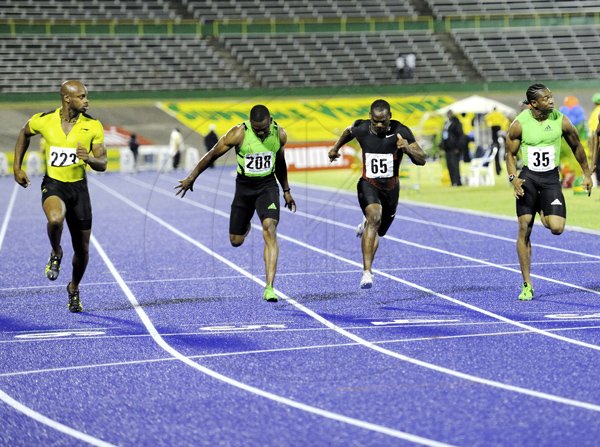 Ricardo Makyn/Staff Photographer
Steve Mullings (right) getting third in the men's 100 metres final behind winner Asafa Powell (left). Powell clocked 10.08 seconds for first, Yohan Blake (not seen) was second in 10.09 and Mullings, third in 10.10.