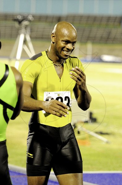 Ricardo Makyn/Staff Photographer
Asafa Powell beams Friday night after winner  the Mens  100 Meters  at the National Trials which ends at the National Stadium today.