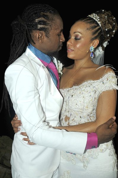 Mark Titus
Reggae Siccaturie Alcock, 'Jah Cure'  and his bride Kamila McDonald  are caught in a loving embrace at their wedding at the luxurious Tryall Club, Sandy Bay, Hanover on Sunday.