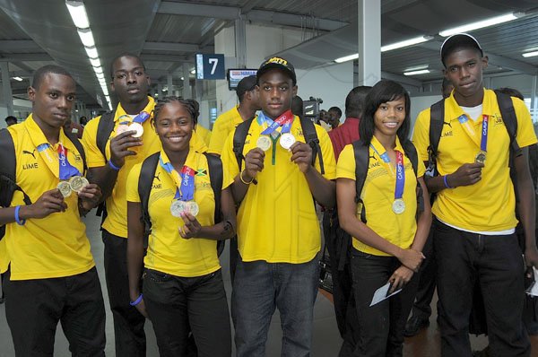Ian Allen/Photographer
Members of the Jamaica Team to the Carifta Games on their arrival home at the Norman Manley International Airport on tuesday.
