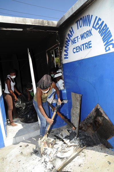 Norman Grindley /Chief Photographer
Residents of Hannah in Town West Kingston put in some labour day work on their burnt out police station yesterday. Residents turned out and clean debris from the station, as they call on the authority to rebuild the station.