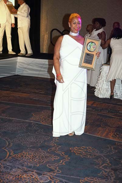 Janet Silvera Photo<\n>Marlene Johnson, one of the top travel specialists from the USA shows off her plaque at the 'One Love Agent' Rewards ceremony at the Moon Palace Jamaica last Saturday night.<\n>                                *** Local Caption *** @Normal:Marlene Johnson, one of the top travel specialists from the USA shows off her plaque at the 'One Love Agent' Rewards ceremony at the Moon Palace Jamaica last Saturday night.