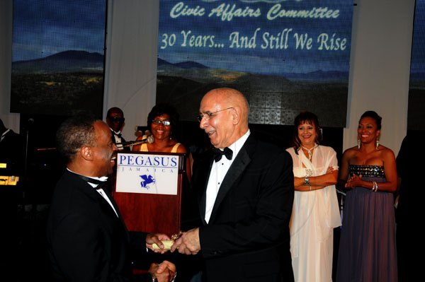 Winston Sill / Freelance Photographer
President of the Jamaica Chamber of Commerce Milton Samuda (left) presents Sameer Younis, chairman of the JCC's Civic Affairs Committee, with a citation to celebrate his contribution to the JCC's programmes and the growth of the charity ball.

of the Jamaica Chambern of Commerce 30th annual Grand Charity Ball, held at the Jamaica Pegasus Hotel, New Kingston on Saturday night November 5, 2011.