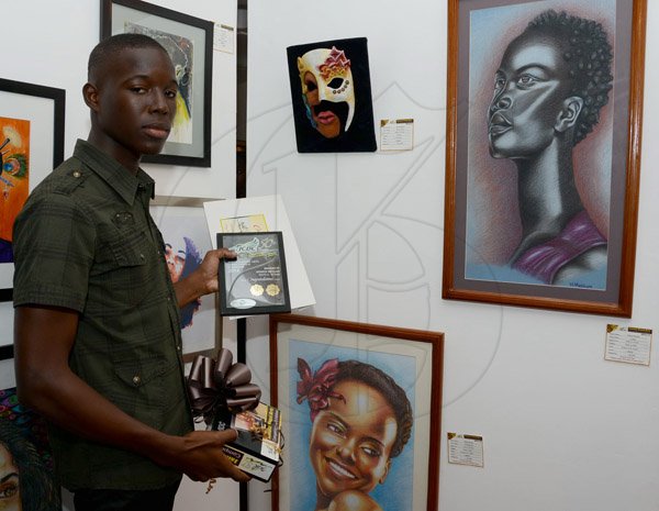 Winston Sill/Freelance Photographer
The Jamaica Cultural Development Commission (JCDC) presents Jamaica Visual Arts Competition Awards and Exhibition, held at the Jamaica Conference Centre, Downtown, Kingston on Sunday December 22, 2013. Here is Winroy Messam with his awards and Gold Medal winning winning works.