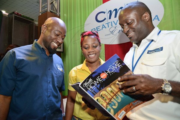 Rudolph Brown/Photographer
Garth Walker, (left) and Simone Riley of Wealth Magazine team show thier magazine with Aswad Morgan, (right) director of marketing, Therapedic Caribbean at the JMA/JEA Expo at the National Arena