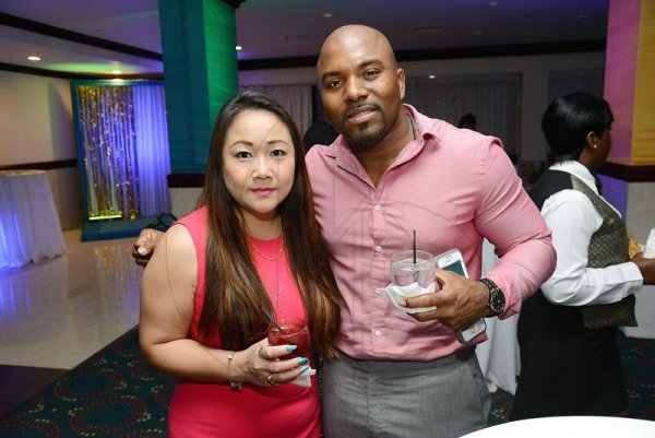Rudolph Brown/ Photographer<\n>Carlene Chang and Dwayney Paul, takes one for the birthday cam.<\n>pose at Joan Forrest-Henry 25/25 birthday celebration with families and friends at the Jamaica Pegasus Hotel in New Kingston on Saturday, June 30, 2018<\n>