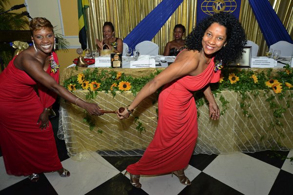 Rudolph Brown/Photographer
Immediate Past President Sharon Williams, (left) pass on the gavel to incoming President Lola Chin Sang at the Kiwanis Club of New Kingston Installation Banquet for the 2012 -2013, officers and Board of Directors at the Terra Nova Hotel in Kingston on Wednesday, October 10, 2012