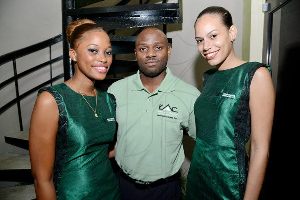 Rudolph Brown/Photographer
Rhyan James pose with Jessica Barrett, (left) and Shawna Campbell at the official of  open of Kris An Charles Investment Company Limited new office at the launch on 2 Eureka Crescent in Kingston on Thursday, September 5, 2013