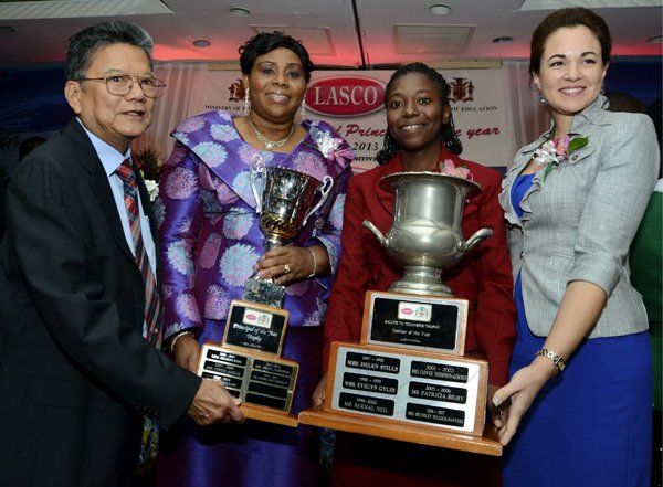 Rudolph Brown/Photographer
Rollington Town Primary School principal Dr. Magared Bailey (second left), the LASCO/Ministry of Education principal of the year, and Dageama Spencer-Hull (second right), teacher of the year from Holland High School, pose with their trophies after Lascelles Chin (right), executive chairman of LASCO Affiliated Companies and Dr. Eileen Chin, (left) Managing Director, LASCO Manufacturing after making the presentation to them during the 2012-2013 Teacher and Principal of the Year Awards at the Wyndham Hotel in New Kingston on Tuesday, December 4, 2012