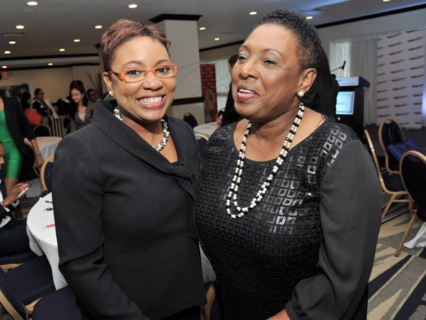 Rudolph Brown/Photographer
Olivia Grange, (right)  pose with Gail Abrahams, Columbus Communications Director of Corporate Communications at the Leaders to Leaders 2014-2015 Series "The Power of Sisterhood Fostering a culture of mentorship at the Jamaica Pegasus Hotel in New Kingston on Wednesday, September 24, 2014
