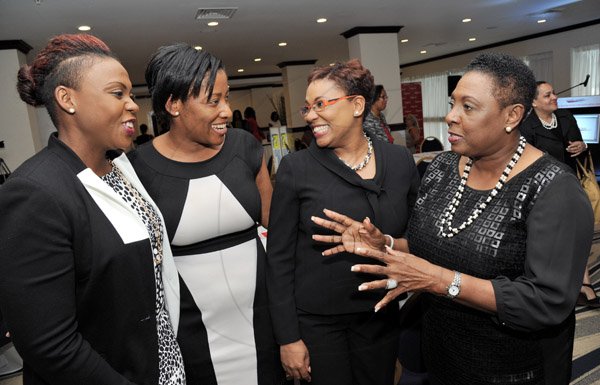 Rudolph Brown/Photographer
Olivia Grange, (right) chat with from left Suzette Hayletts, Financial Controlle, Columbus and Gail Abrahams, Columbus Communications Director of Corporate Communicationsat the Leaders to Leaders 2014-2015 Series "The Power of Sisterhood Fostering a culture of mentorship at the Jamaica Pegasus Hotel in New Kingston on Wednesday, September 24, 2014