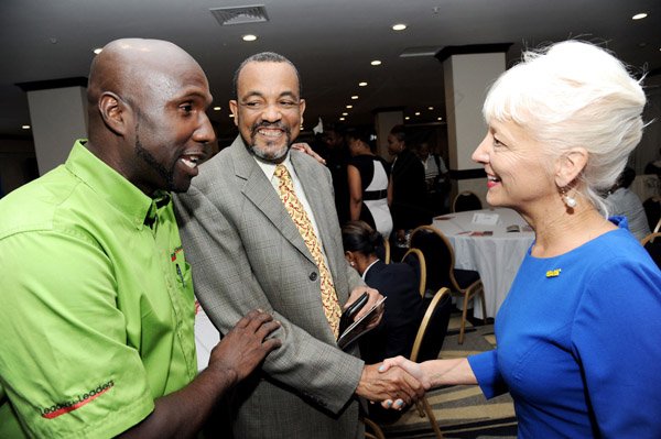 Rudolph Brown/Photographer
Kelly Tomblin CEO, JPSCO greets Captain Sydney Innis, (centre) and Delroy Morgan at the Leaders to Leaders 2014-2015 Series "The Power of Sisterhood Fostering a culture of mentorship at the Jamaica Pegasus Hotel in New Kingston on Wednesday, September 24, 2014