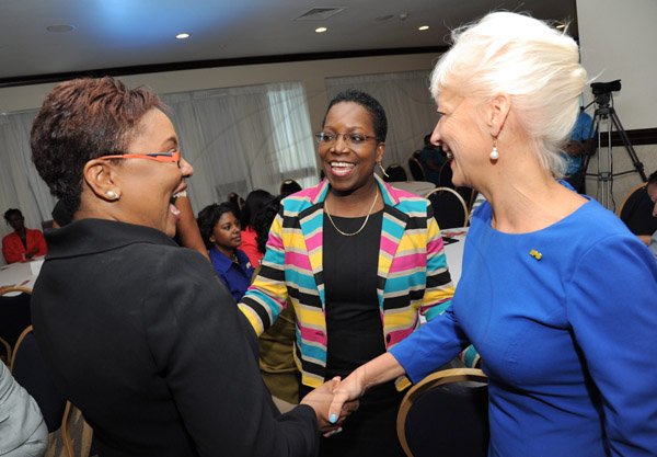 Rudolph Brown/Photographer
Kelly Tomblin, (right) CEO of JPSCO share a joke with Winsome Callum, (centre) Director Corporate Communications JPSCO and Gail Abrahams, Columbus Communications Director of Corporate Communications 
 at the Leaders to Leaders 2014-2015 Series "The Power of Sisterhood Fostering a culture of mentorship at the Jamaica Pegasus Hotel in New Kingston on Wednesday, September 24, 2014