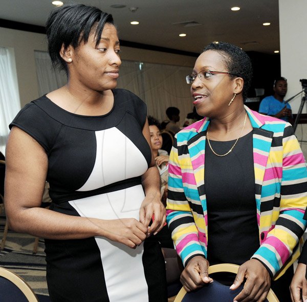 Rudolph Brown/Photographer
Winsome Callum, (right) Director Corporate Cummincations, JPSCO chat with Tanikie McClarthy, corporate affairs executive of Flow at the Leaders to Leaders 2014-2015 Series "The Power of Sisterhood Fostering a culture of mentorship at the Jamaica Pegasus Hotel in New Kingston on Wednesday, September 24, 2014