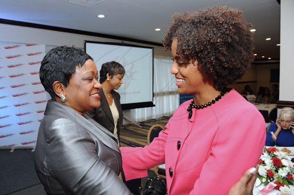 Rudolph Brown/Photographer
Minna Isreal, (left) greets Senator Imani Duncan-Price at the Leaders to Leaders 2014-2015 Series "The Power of Sisterhood Fostering a culture of mentorship at the Jamaica Pegasus Hotel in New Kingston on Wednesday, September 24, 2014