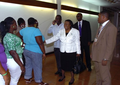 Norman Grindley/Chief Photographer
Dorothy Lightbourne, (centre) the minister of justice and attorney general is being greeted by supporters as she arrived at  the Manatt-Dudus Commission of Enquiry at the Jamaica Conference Centre, downtown Kingston. Lightbourne arrived at conference centre 9:25 am and will testify after Lieutenant Colonel Patrick Cole today March 3, 2011.
