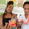 Rudolph Brown/Photographer
Katherine King, (right) of Stoosh Bums show Cadia Griffon her company baby products at the Twelve Tribes of Isreal Irie Livity Expo at the Headquarters on Hope Road in Kingston on Sunday, 28, 2013