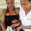 Rudolph Brown/Photographer
Katherine King, (right) of Stoosh Bums show Cadia Griffon her company baby products at the Twelve Tribes of Isreal Irie Livity Expo at the Headquarters on Hope Road in Kingston on Sunday, 28, 2013