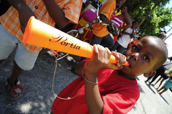 Ricardo Makyn/Staff Photographer
A Youngster blows a Portia Horn in Whitfield Town  on Election Day