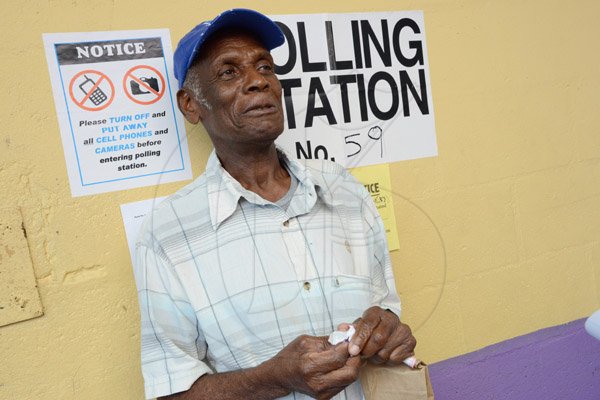 Rudolph Brown/Photographer
Cecil Shettlewood leaving the Pembroke Hall High School Polling Station shortly after he voted on Local Government election on Monday November 28, 2016