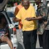 Jermaine Barnaby/Freelance Photographer
Eighty seven year old Sylvester Simms being assisted to a polling station in August Town during the local Government election on Monday November 28, 2016.