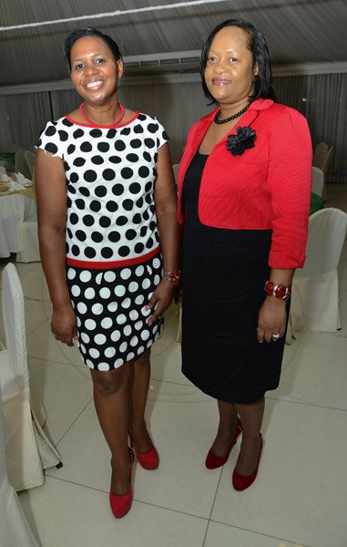 Rudolph Brown/Photographer
Sandra Thompson, (right) general manager of St. Catherine Credit Union pose with Karett Williamsat the credit union's 35th anniversary annual long service awards luncheon  at the Terra Nova Hotel in Kingston on Wednesday, December 5,2012