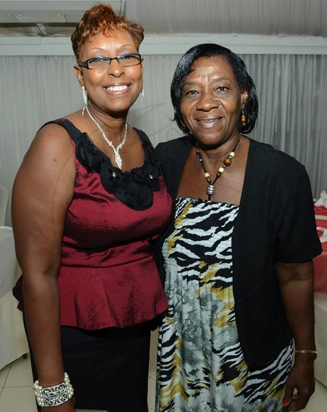 Rudolph Brown/Photographer
Yvonne Purcell, (left) secretary of St. Catherine Credit Union  with Melva Grier Jones at the credit union's 35th anniversary annual long service awards luncheon  at the Terra Nova Hotel in Kingston on Wednesday, December 5,2012