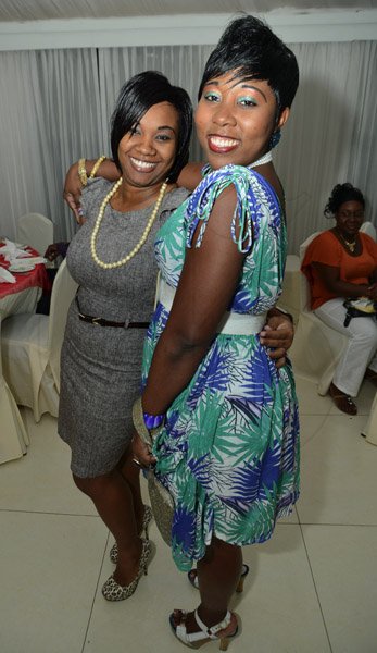 Rudolph Brown/Photographer
Kennisha Gray, (left) pose with Roxanne Clacken at the credit union's 35th anniversary annual long service awards luncheon  at the Terra Nova Hotel in Kingston on Wednesday, December 5,2012