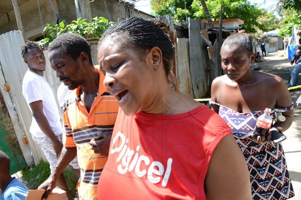Rudolph Brown/Photographer
Jennifer McDonald, (centre) Mother and grandmother mourning the death of family after gunmen shoot up seven killing five including three children and set their home ablaze at Africa settlement in March Pen Community in Spanish Town on Sunday, October 9