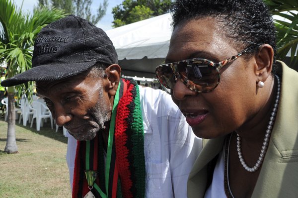 Rudolph Brown/Photographer
Olivia Grange, Opposition Spokesperson on Youth, Sports chat with Frank Gordon at the Floral Tribute commemorating the 125th Anniversary of the birth The Rt. Excellent Marcus Mosiah Garvey, Jamaica National Hero at the National Heroes Park in Kingston on Friday, August 17-2012