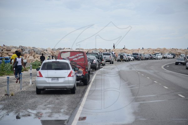 Gladstone Taylor/ Photographerscores of persons flocked to the Palisadoes strip on Monday september 3, 2016 to view the large waves crashing along the shoreline.