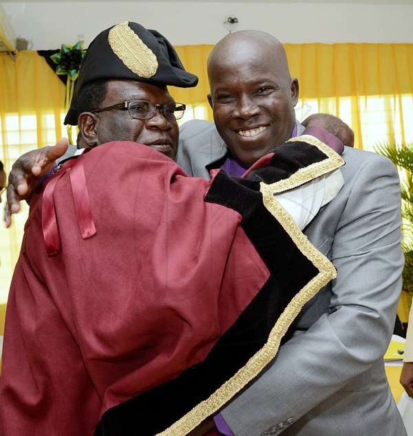 Rudolph Brown/Photographer
Deputy Mayor Edwin Marr, (right) greets His Worship the Mayor Ludlow Mathison after the Investiture ceremony for the conferment of Titles of Mayor and Deputy Mayor of Morant Bay at Casa Lagoona Hotel, Pamphret St. Thomas on Wednesday, May 14, 2014