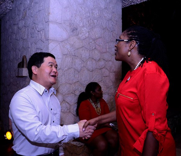 Winston Sill/Freelance Photogtapher
KSAC Mayor Angela Brown-Buirke host Christmas, Media and Corporate Mingle, held at Villa Ronai, Old Stony Hill Road on Friday night December 27, 2013. Here are Dong Xiaojun (left), Chinese Ambassador; and Mayor Brown-Burke (right).