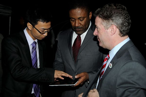 Winston Sill / Freelance Photographer
Digicel and Huawei presents the launch of the new Huawei Media Pad, held at Devon House, Hope Road on Monday night November 12, 2012. Here are Ricardo Xiao Hua (left), General Manager, Huawei Technologies Ja. Ltd.; Minister Phillip Paulwell (centre); and Andy Thorburn (right), CEO, Digicel.