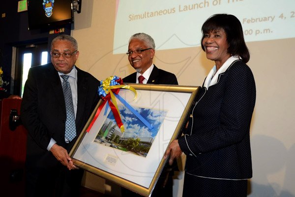 Winston Sill/Freelance Photographer
Prime Minister Portia Simpson-Miller opens UWI's   Faculty of  Medical Sciences' Teaching and Research Complex, and Launch of The UWI, Mona Dental Programme, held at West Road, UWI  Mona Campus, on Wednesday February 4 , 2015.  Here Principal Prof. Archibald McDonald (left); and Vice Chancellor Prof. E. Nigel Harris (centre)  makes a presentation to Prime Minister Portia Simpson-Miller (right).