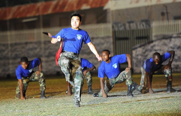 Ian Allen/Photographer
A member of the People's Republic of China Liberation Army joins Jamaica Defence Force troops in showing off their agility at the Jamaica Military Tattoo at Up Park Camp on Thursday June 28.
